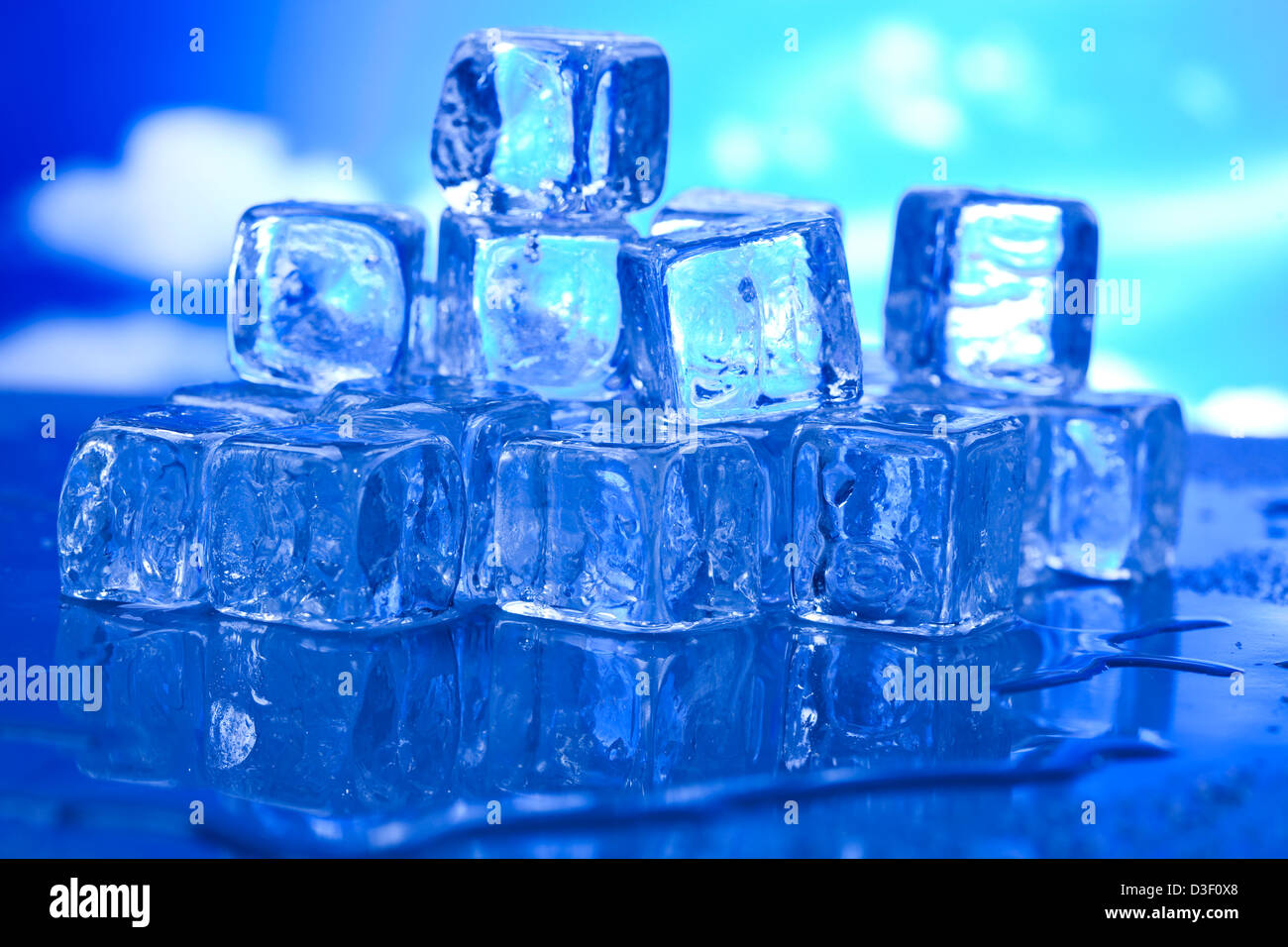 Transparent ice cubes and blue sky background Stock Photo - Alamy