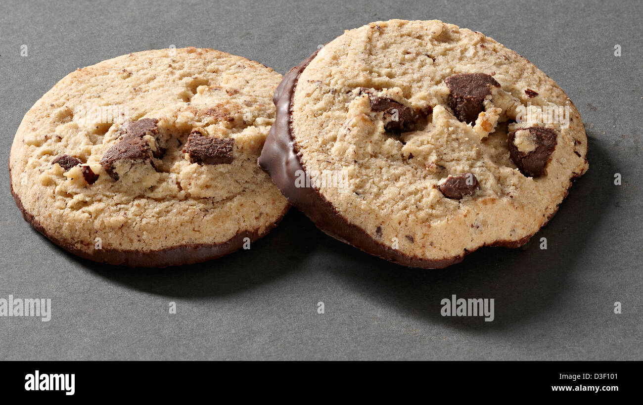 Two chocolate chunk & hazelnut dipped biscuits Stock Photo