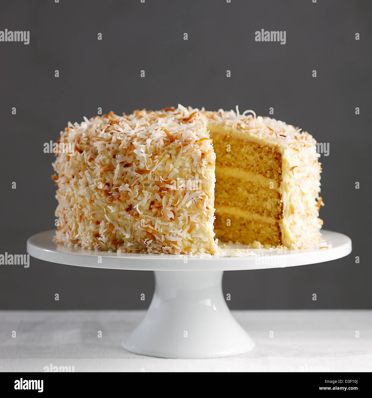 Coconut saffron cake white stand toasted Stock Photo