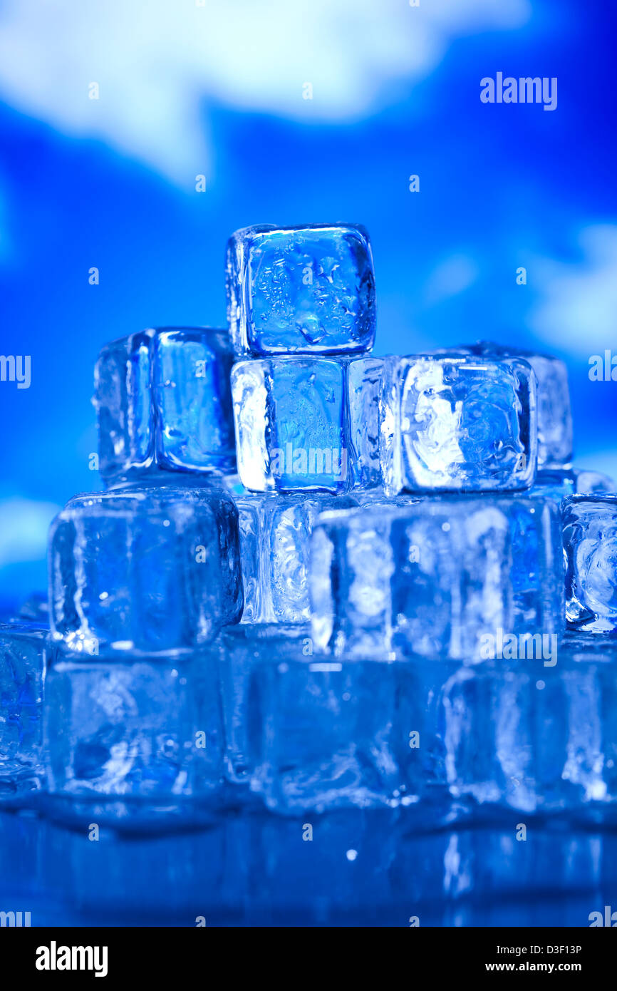 Transparent ice cubes and blue sky background Stock Photo - Alamy