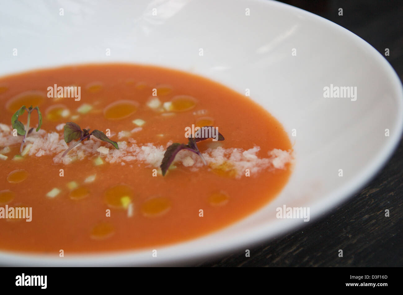 Tomato Gazpacho served with crushed breadcrumbs, cucumber & purple shiso Stock Photo