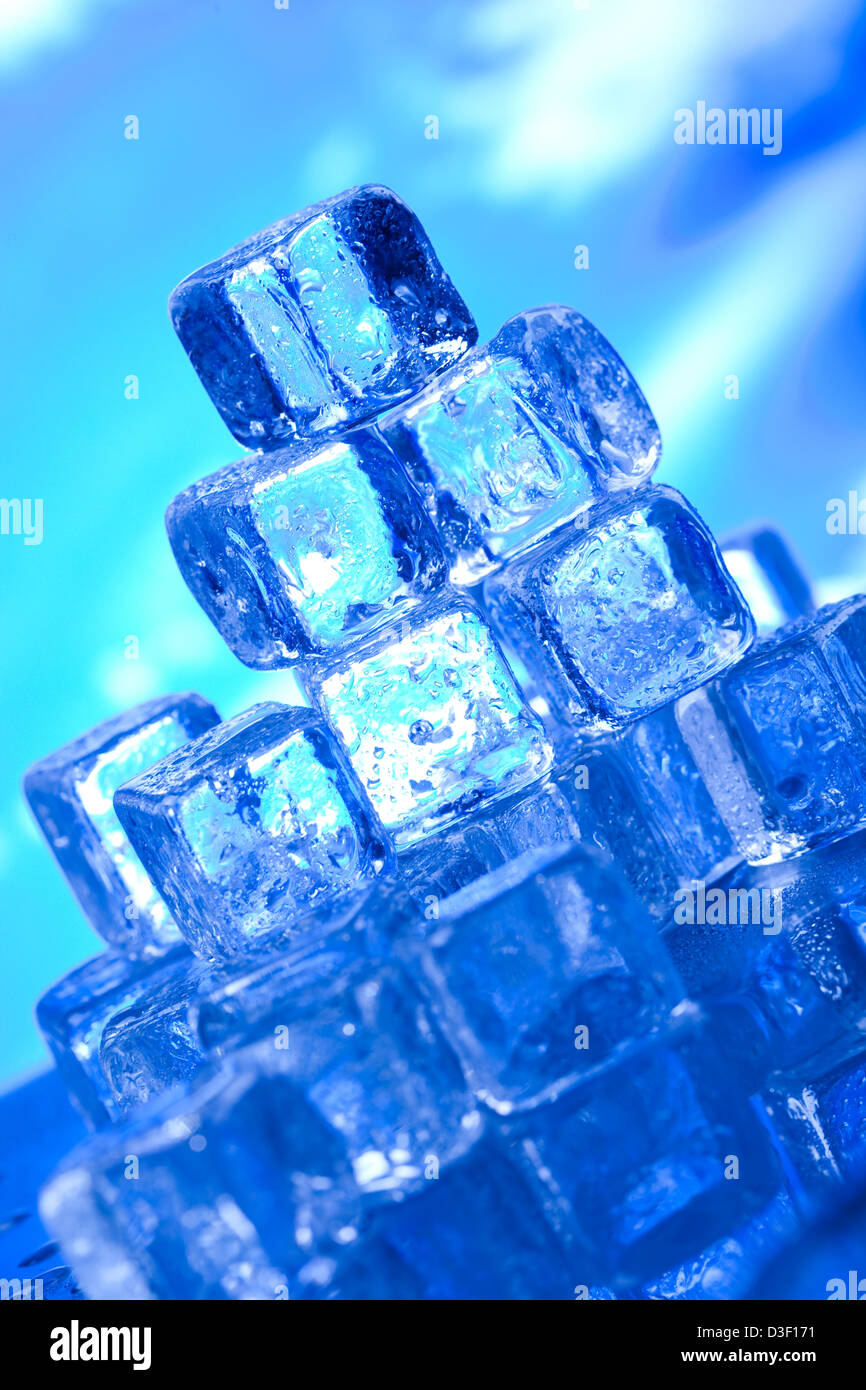 Transparent ice cubes and blue sky background Stock Photo - Alamy