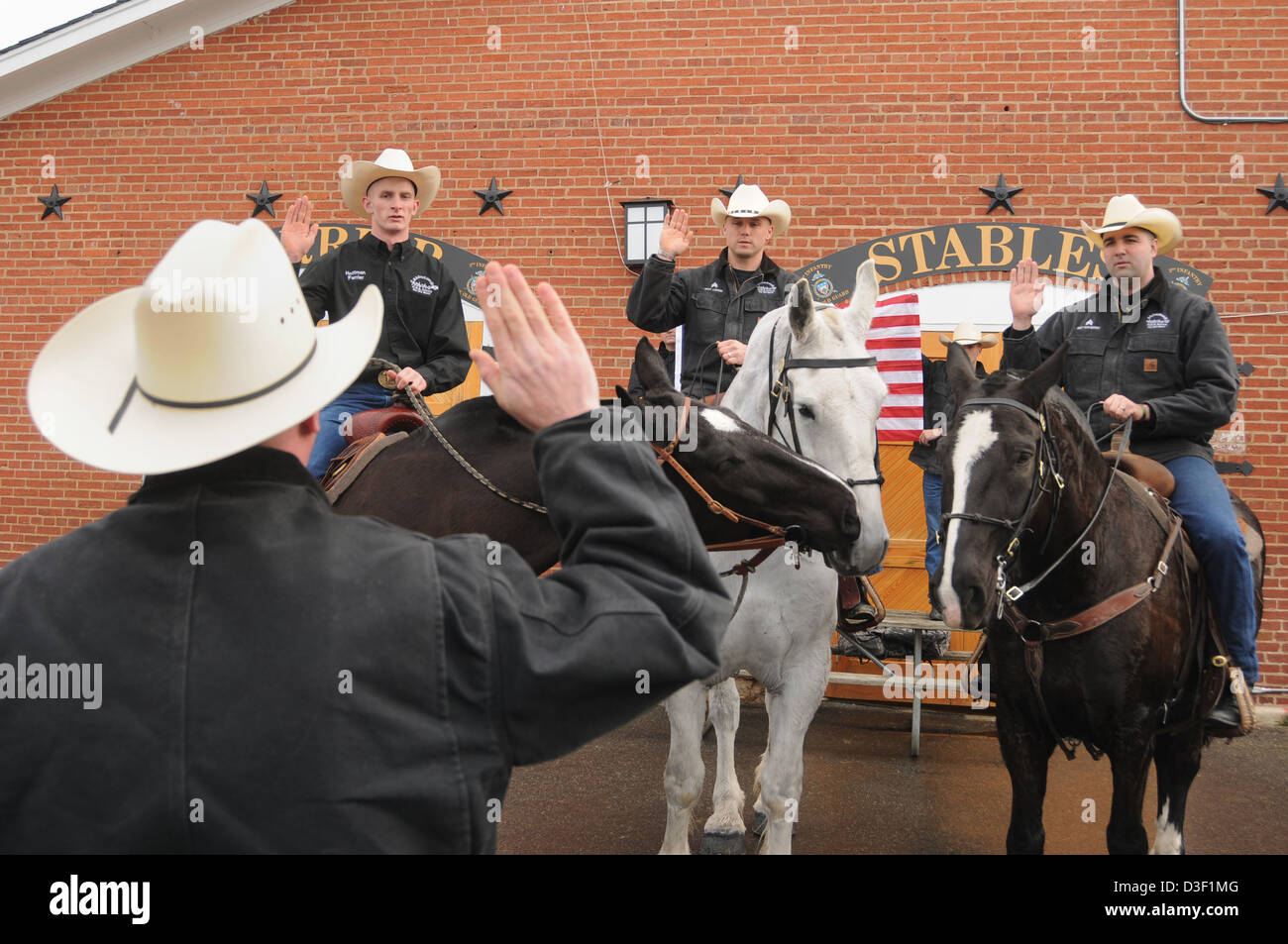 Wearing cowboy hats soldiers in the US Army 3rd Infantry Regiment, The Old Guard, re-enlistment while mounted on horses behind the Caisson Barn February 13, 2013 at Joint Base Myer-Henderson Hall, VA. Stock Photo