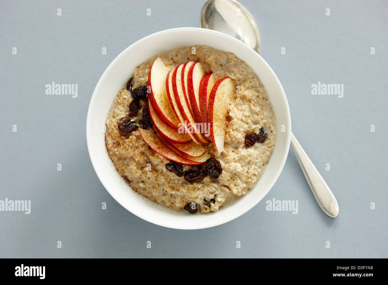 Porridge oats raisins cinnamon rice milk red apple Stock Photo