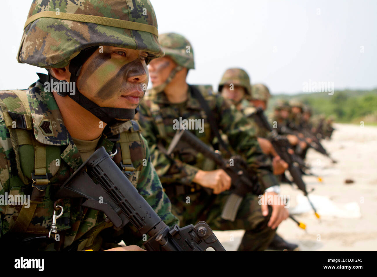 Royal Thai Marines assemble after coming ashore during a beach landing exercise during Cobra Gold 2013 February 15, 2013 in Hat Yao, Thailand. Cobra Gold is an annual event with the United States and Kingdom of Thailand to increase readiness in the Asia-Pacific region. Stock Photo
