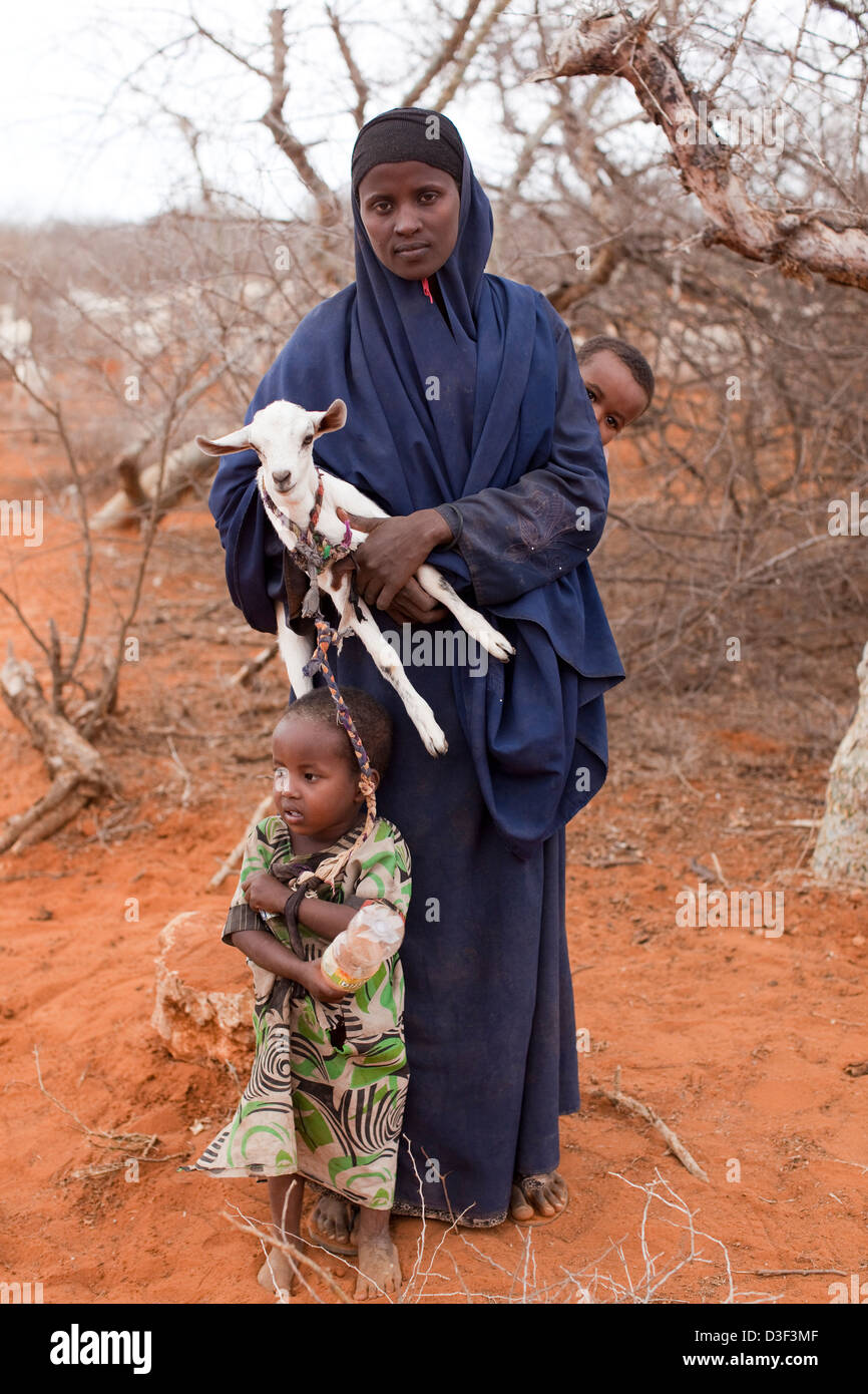 GURAH, NORTH OF ELWAK, EASTERN KENYA, 1st SEPTEMBER 2009: A mother with her two young children and a baby goat at Gurah Stock Photo