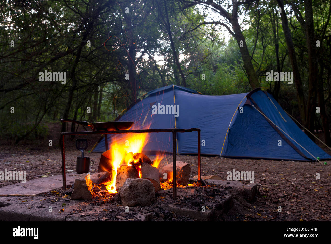 Camp fire cooking and tent Stock Photo