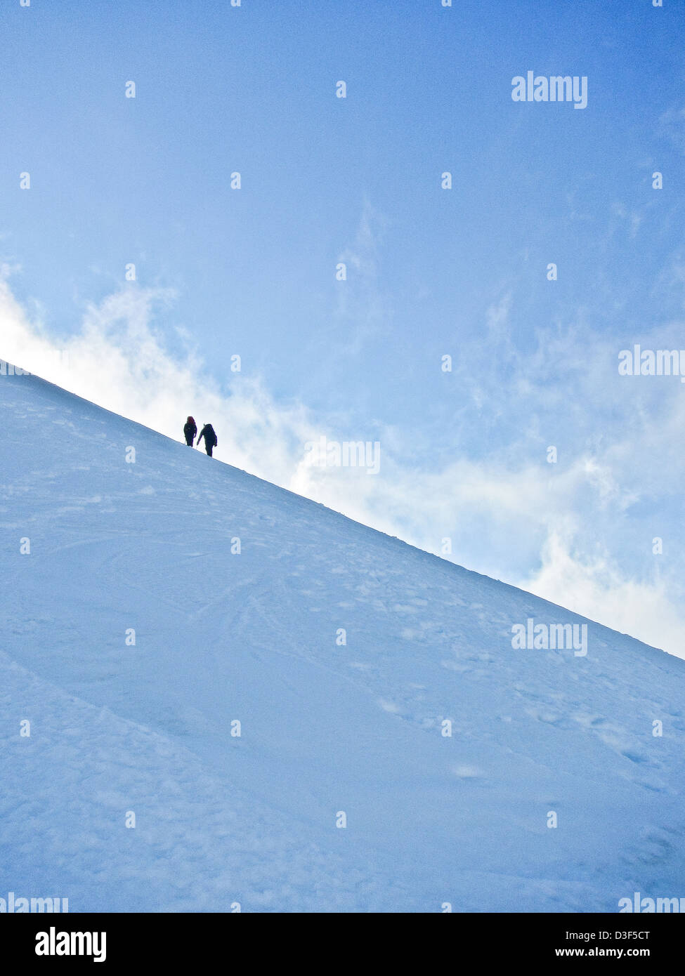 Two mountaineers on a snow slope in Scotland in Winter Stock Photo