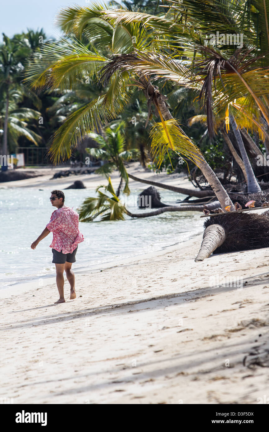 Man on a tropical beach among palm trees Stock Photo