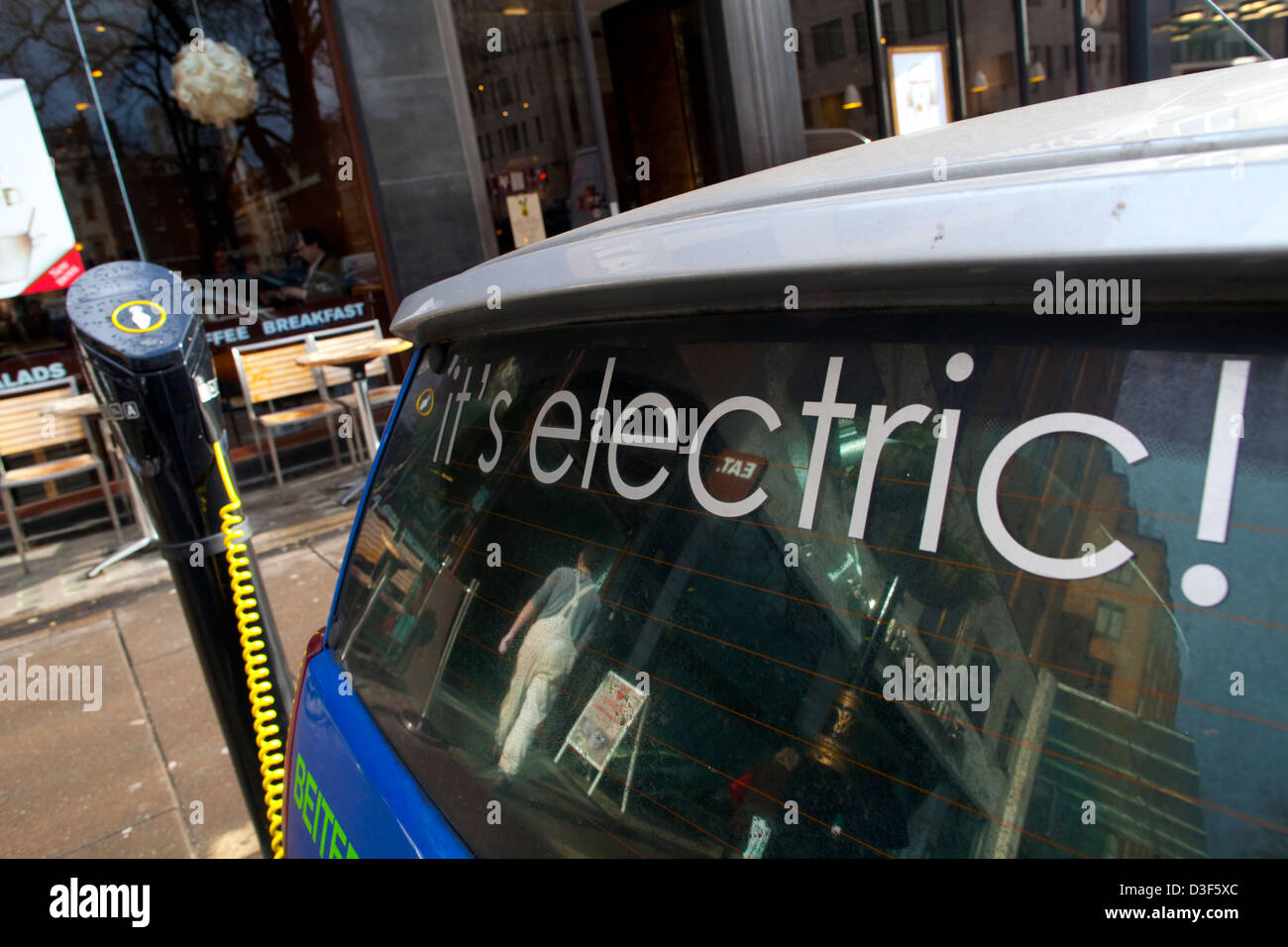 G Wiz Reva electric car parked at charging bay, Berkeley Square, London, England, UK Stock Photo