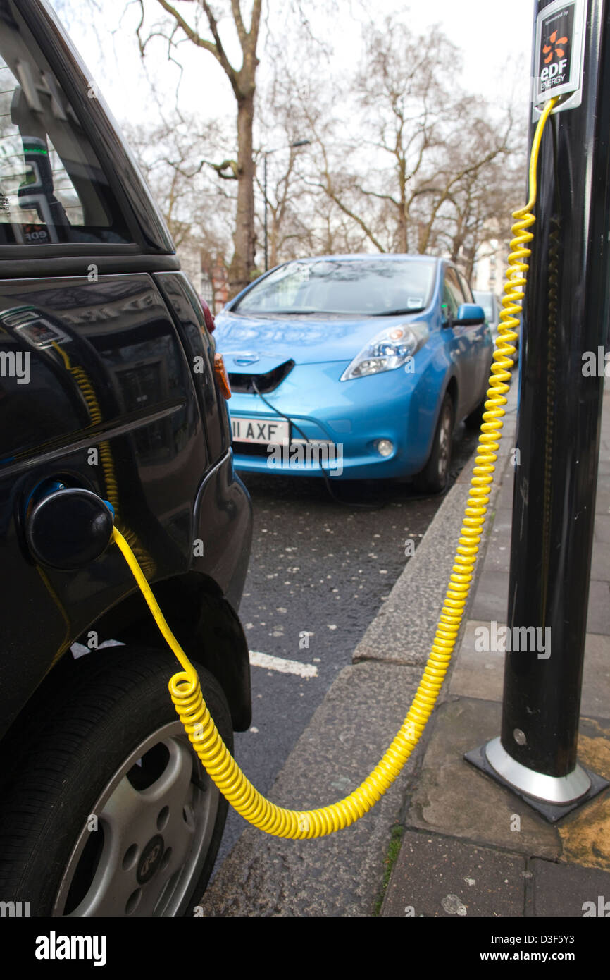 G Wiz Reva electric car parked at charging bay, Berkeley Square, London