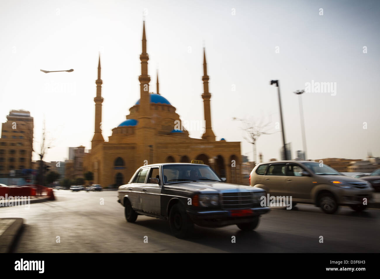 Taxi driving in front of the Mohammad Al-Amin Mosque in Beirut, Lebanon, next to Rafic Hariri's tomb. Stock Photo