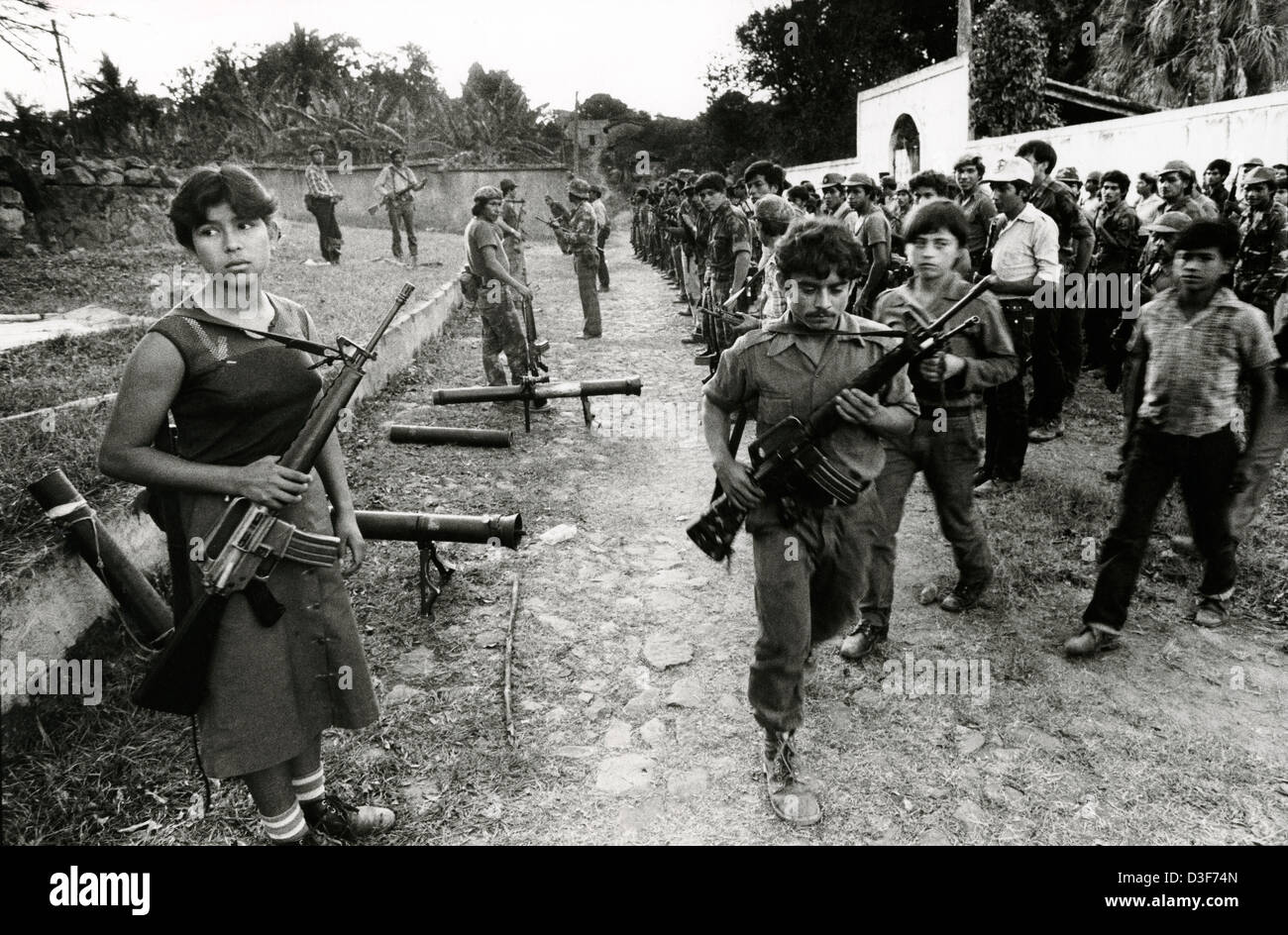 TENANCINGO,  EL SALVADOR, FEB 1984: - Within the FPL Guerilla's Zones of Control - Some of the 1,000 guerrillas that had been gathered in preparation for a guerilla offensive, less than 40 miles from the capital, fall out after parade.   Photo by Mike Goldwater Stock Photo