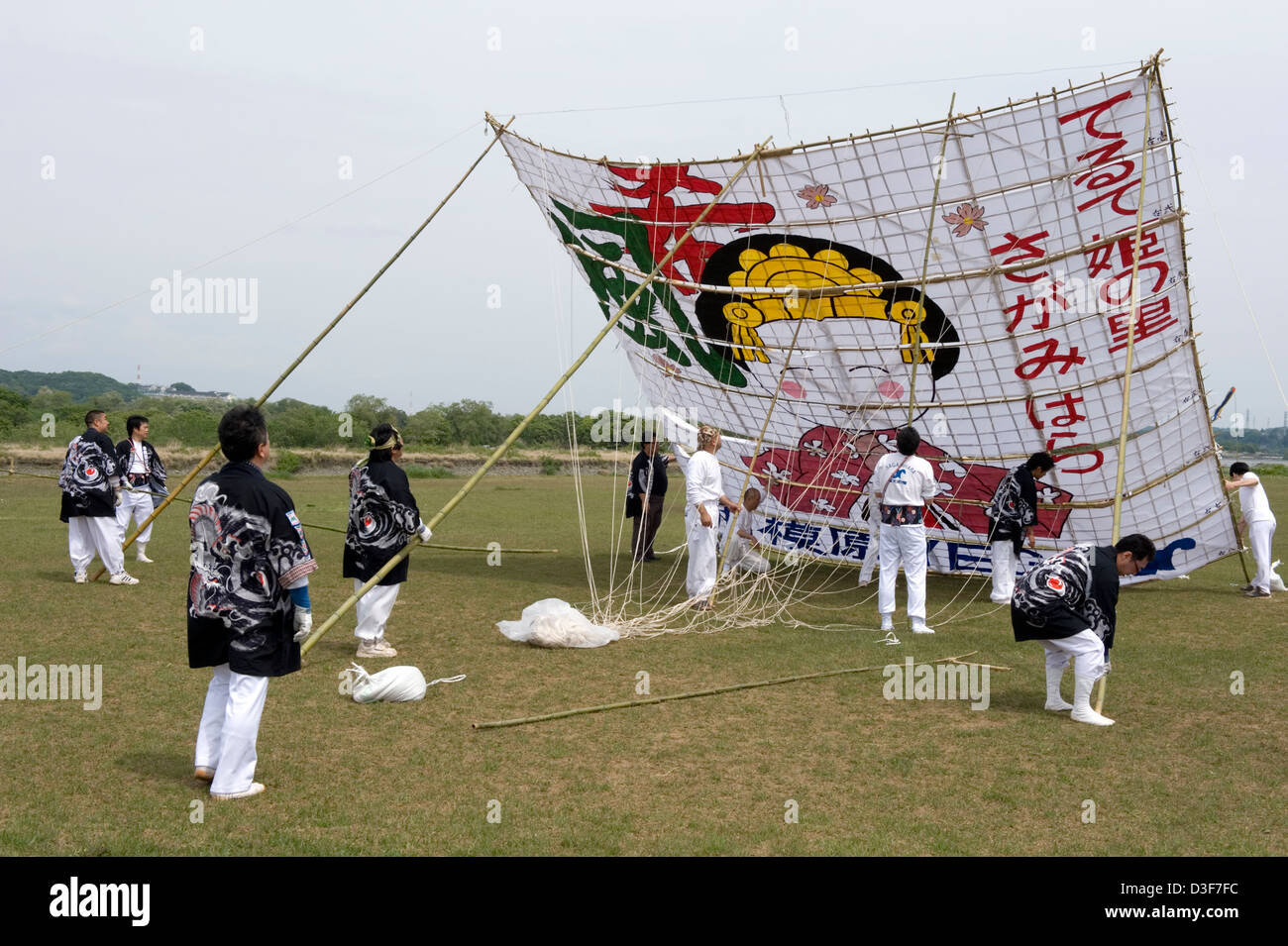 Team making preparations to giant paper and bamboo kite at Sagami no