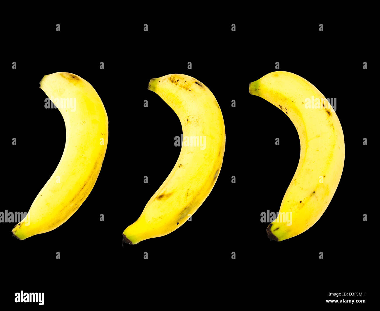 Three ripe bananas isolated on black background Stock Photo