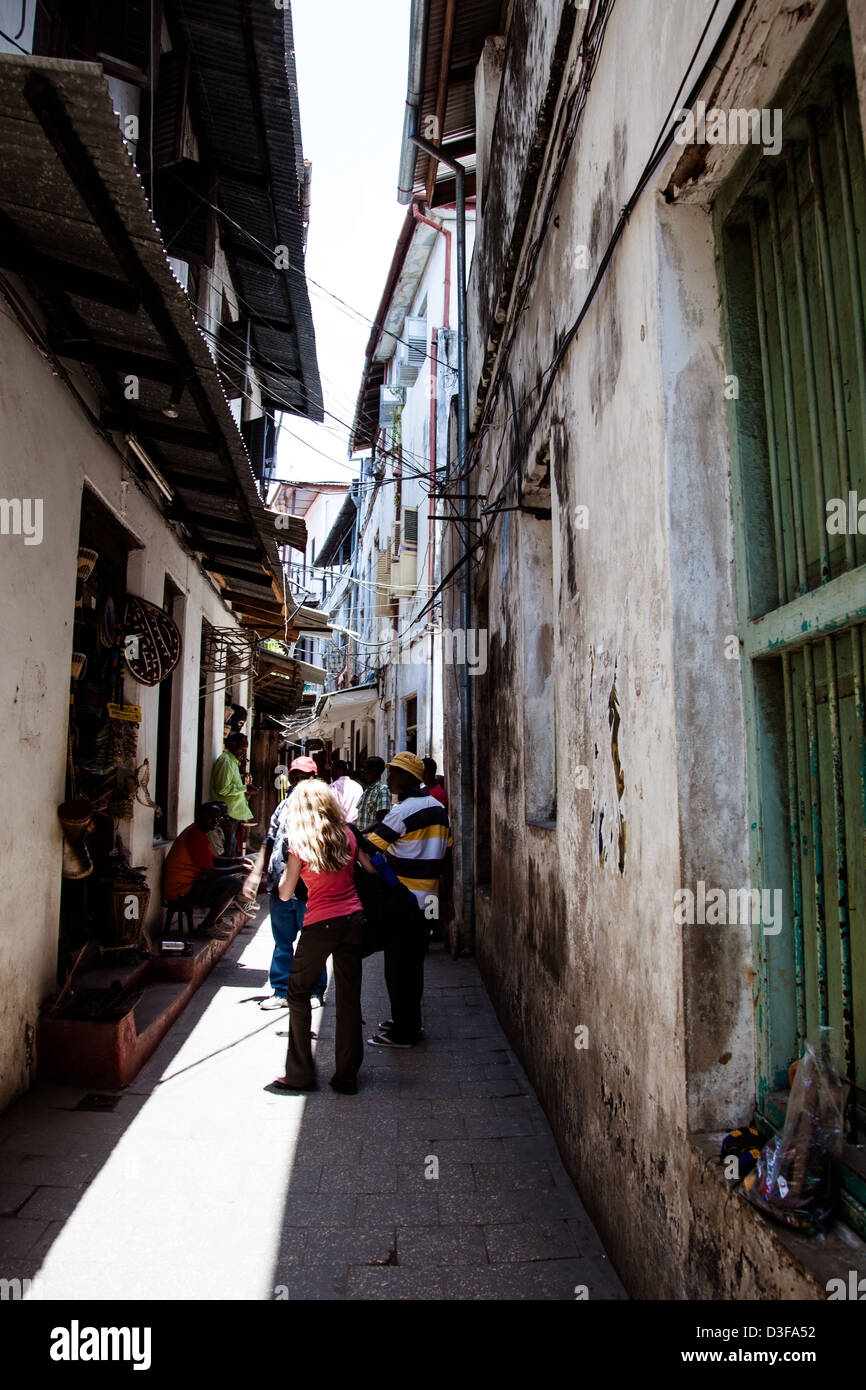 Locals and Tourists haggle in the alley shops of Stonetown, Zanzibar, Tanzania. Stock Photo
