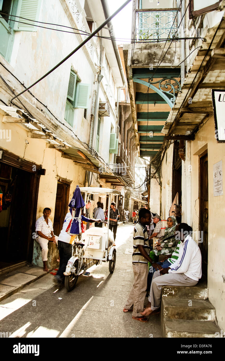 Locals and Tourists haggle in the alley shops of Stonetown, Zanzibar, Tanzania. Stock Photo