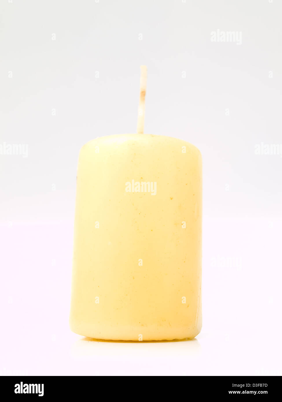 Tall yellow wax candle on white Stock Photo Alamy