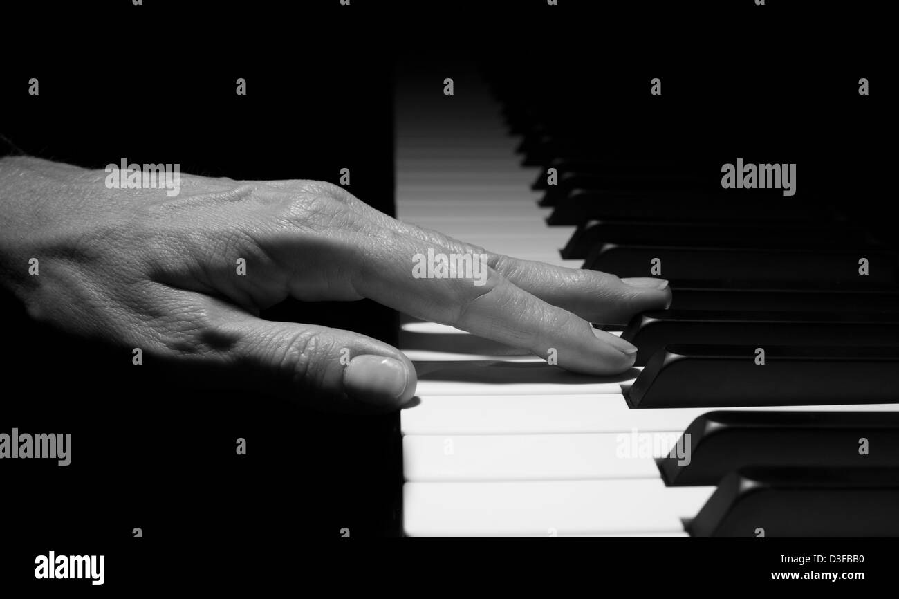 Hand on piano keys Stock Photo Alamy