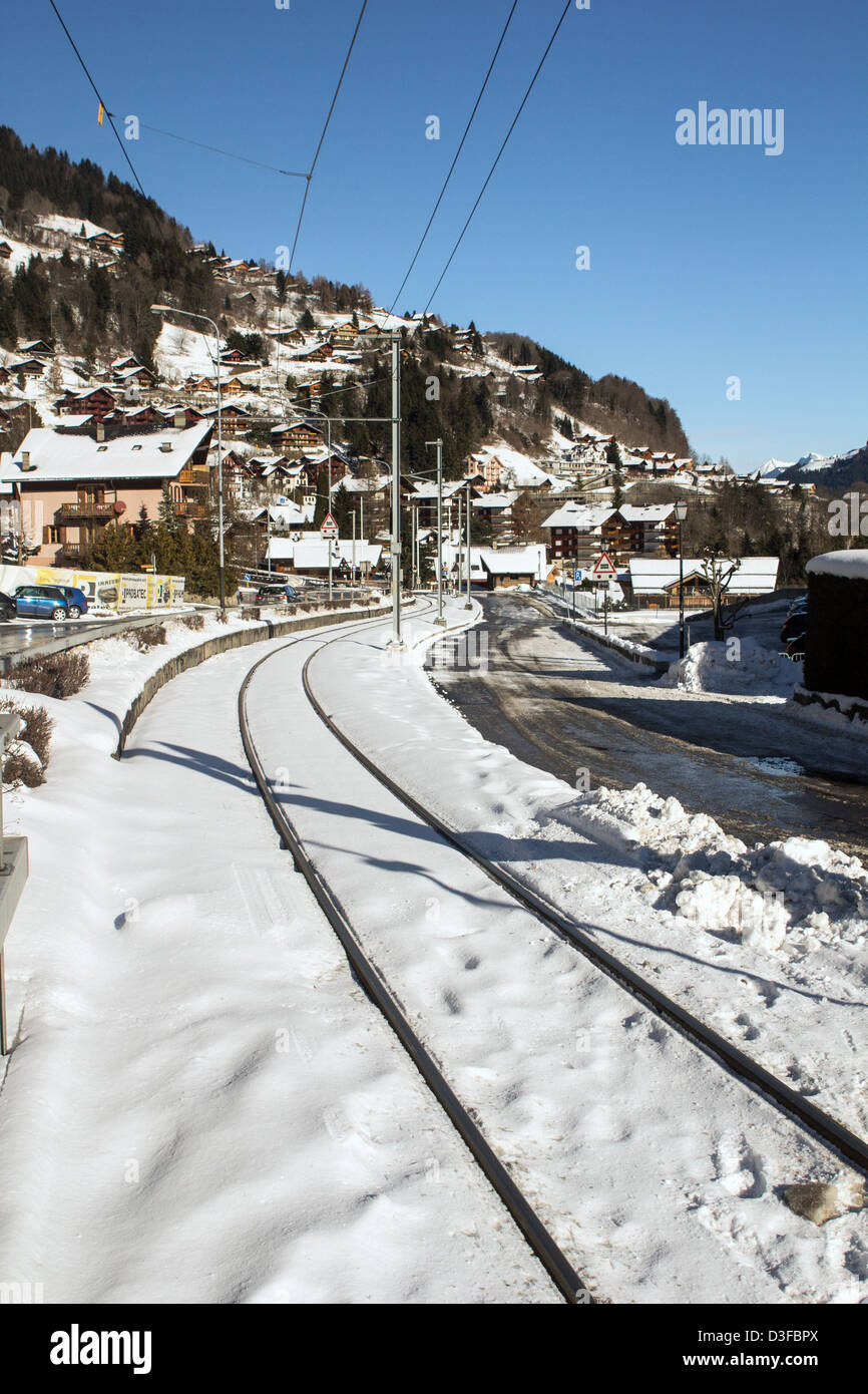 Train tracks through a snow covered town Stock Photo