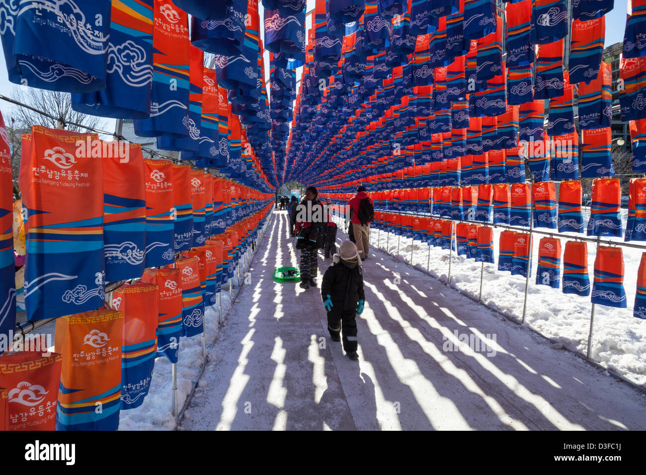 Ottawa, Canada, February 18, 2013.  Visitors of Ottawa Winterlude walk through the Tunnel of Lanterns at Confederation Park,  The 18-day winter festival wraps up today. Stock Photo
