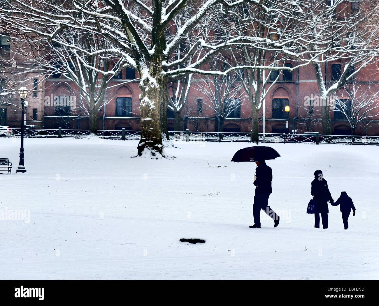 People walking in snow in New Haven CT USA on the center green Stock