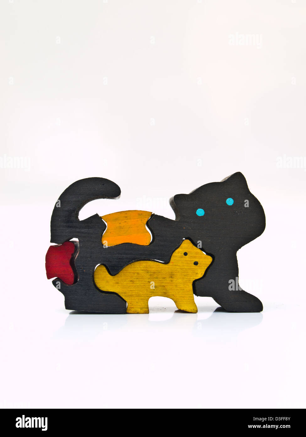 A colorful wooden puzzle cat isolated on white background Stock Photo ...