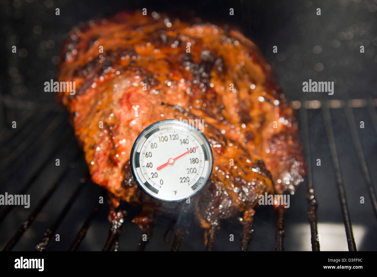 Thermometer reading temperature of smoking meat Stock Photo Alamy