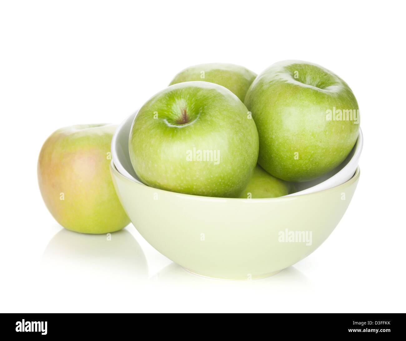 Green apples in fruit bowl. Isolated on white background Stock Photo