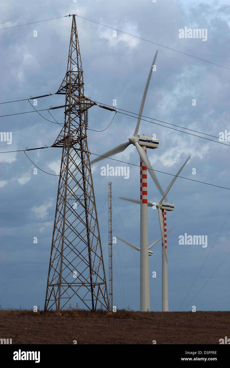 Porto Torres, Italy, wind power pole and wheels of the power utility Enel SpA Stock Photo