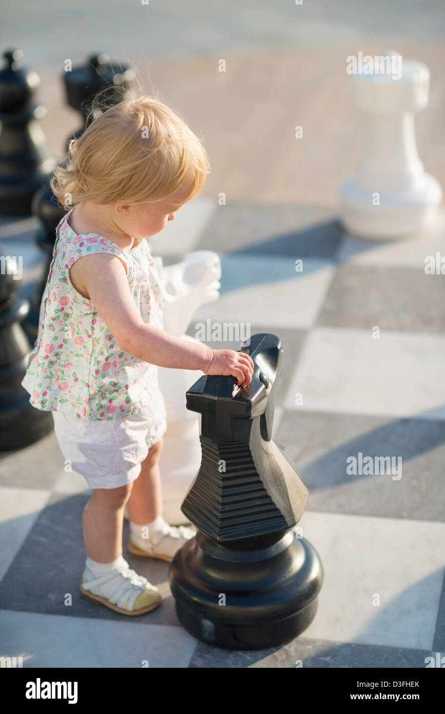 Baby girl playing with chess Stock Photo