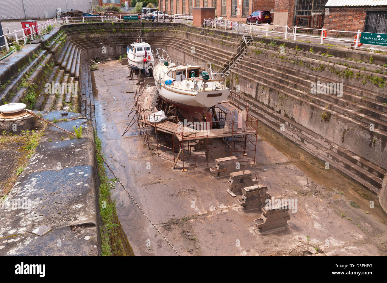 Working Dry Docks for maintenance and repair work on vessels, managed by T Nielsen & Co, Gloucester Docks, Gloucestershire Stock Photo