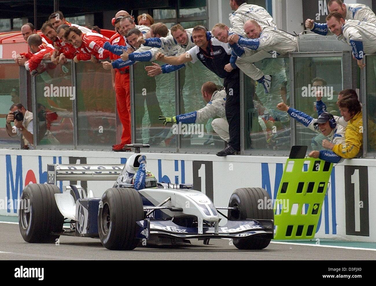 Dpa German Formula One Pilot Ralf Schumacher Bmw Williams Drives Past Cheering Mechanics After Winning The French Formula One Grand Prix In Magny Cours France 6 July 03 It Was Ralf Schumacher S Second Dpa German Formula One Pilot Ralf Schumacher Bmw Williams Drives Past Cheering Mechanics After Winning The French Formula One Grand Prix In Magny Cours France 6 July 03 It Was Ralf Schumacher S Second