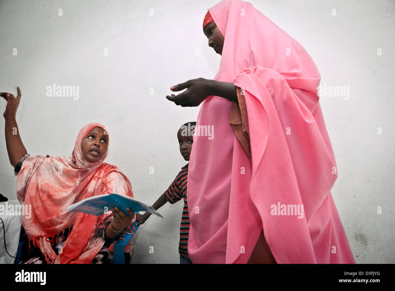A nurse discusses with a mother inside the UN-run hospital at the main AMISOM military base at Aden Ade International Airport. Stock Photo