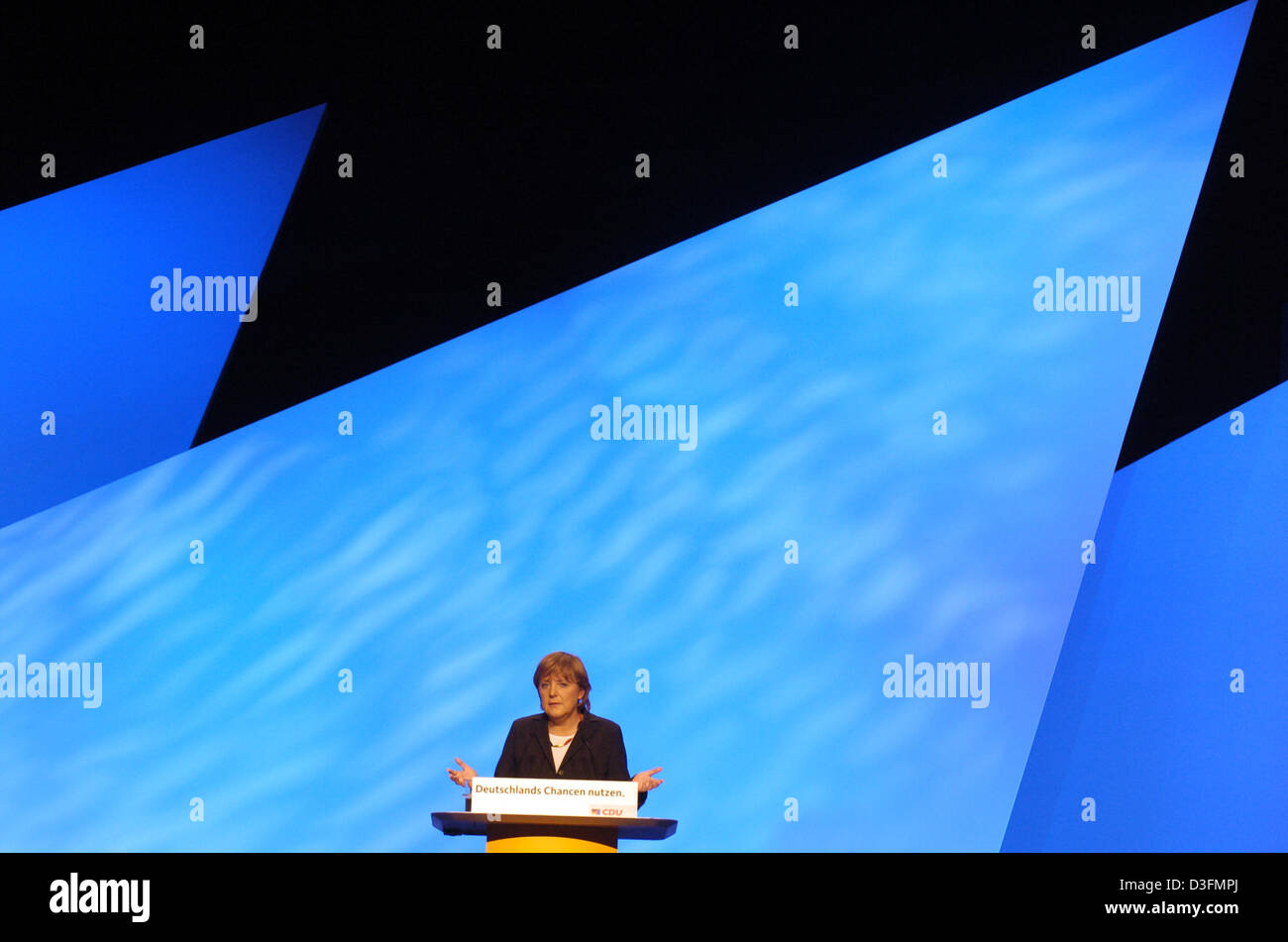 (dpa) - Angela Merkel, Leader of the German Christian Democratic Union (CDU), gives a speech in front of the stage decoration during the CDU's 18th party congress in Duesseldorf, Germany, 6 December 2004. The party congress takes place under the motto 'Deutschlands Chancen nutzen' (to use Germany's chances). Stock Photo