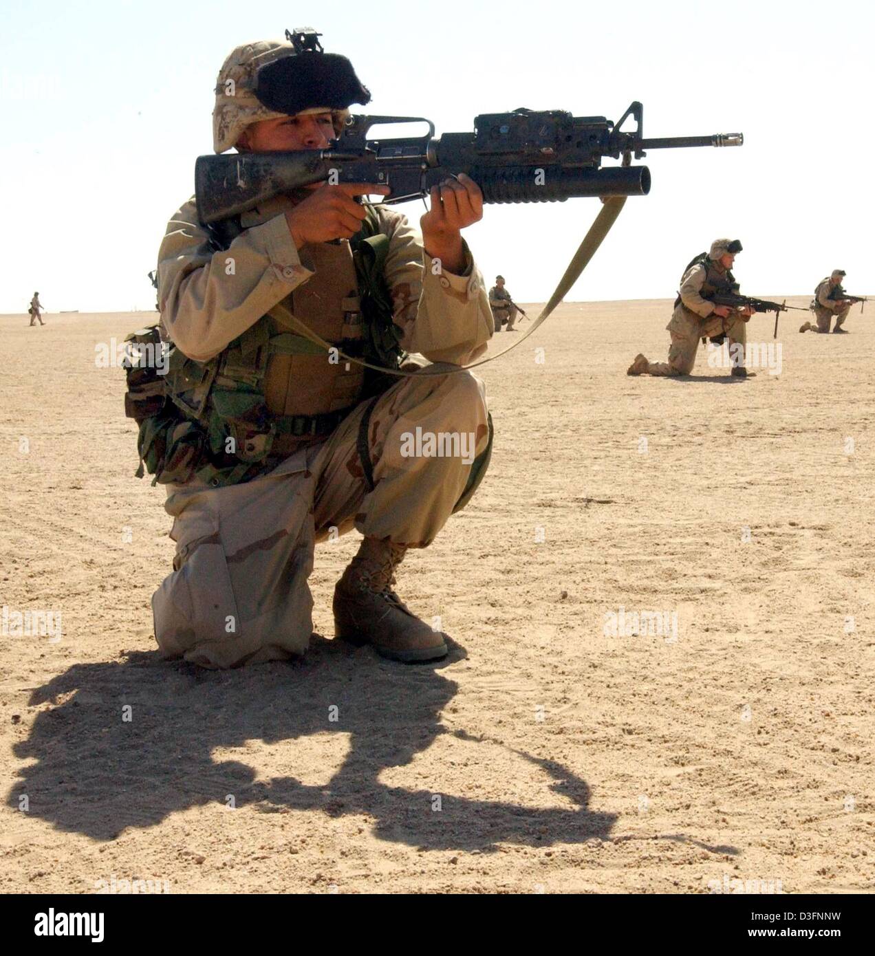 (dpa) - A US marine of the 3rd Infantry Battalion practises shooting with live ammunition in Camp Coyote in Kuwait, Asia, 15 March 2003. More than 150,000 US and British soldiers are presently based in Kuwait's northern desert. According to the US Department of Defense, these soldiers are prepared to launch an attack on Iraq. Stock Photo