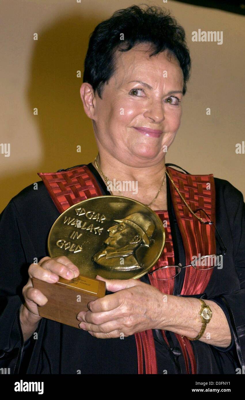 (dpa) - Finnish actress Ann Savo shows her Edgar Wallace Prize in Gold in Titisee-Neustadt, Germany, 12 April 2003. The 70-year-old actress was honoured for her achievements for the German crime movies. Among other films, she appeared in the German Edgar Wallace films 'Der Hexer' ('The Mysterious Magician', 1964) and 'Die toten Augen von London' ('The Dead Eyes of London', 1961). Stock Photo