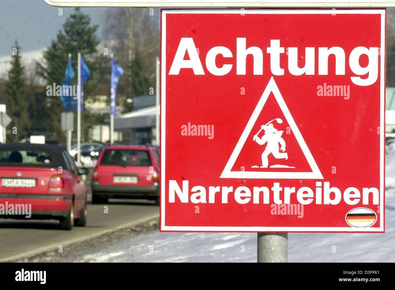 (dpa) - A traffic sign warns drivers to beware of people in fancy dresses who celebrate carnival ('Achtung Narrentreiben'), in Elzach, Germany, 19 February 2003. A fortnight before Carnival Monday, fools and clowns are allowed to celebrate in the streets and on the squares of the city. Stock Photo