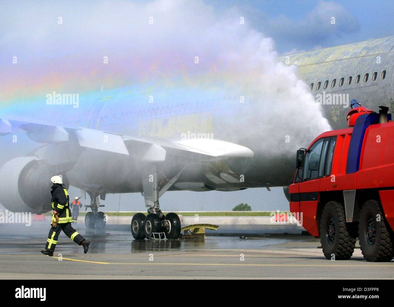 (dpa) - Airport fire fighters are pictured during the emergency exercise 'Lilienthal 03' at the airport in Dresden, Germany, 7 May 2003. The airport in Dresden is obliged to carry out such an exercise every two years to controll the coordination and planing of the rescue services. In this case a take-off accident with fire and loss of kerosene is simulated. Stock Photo