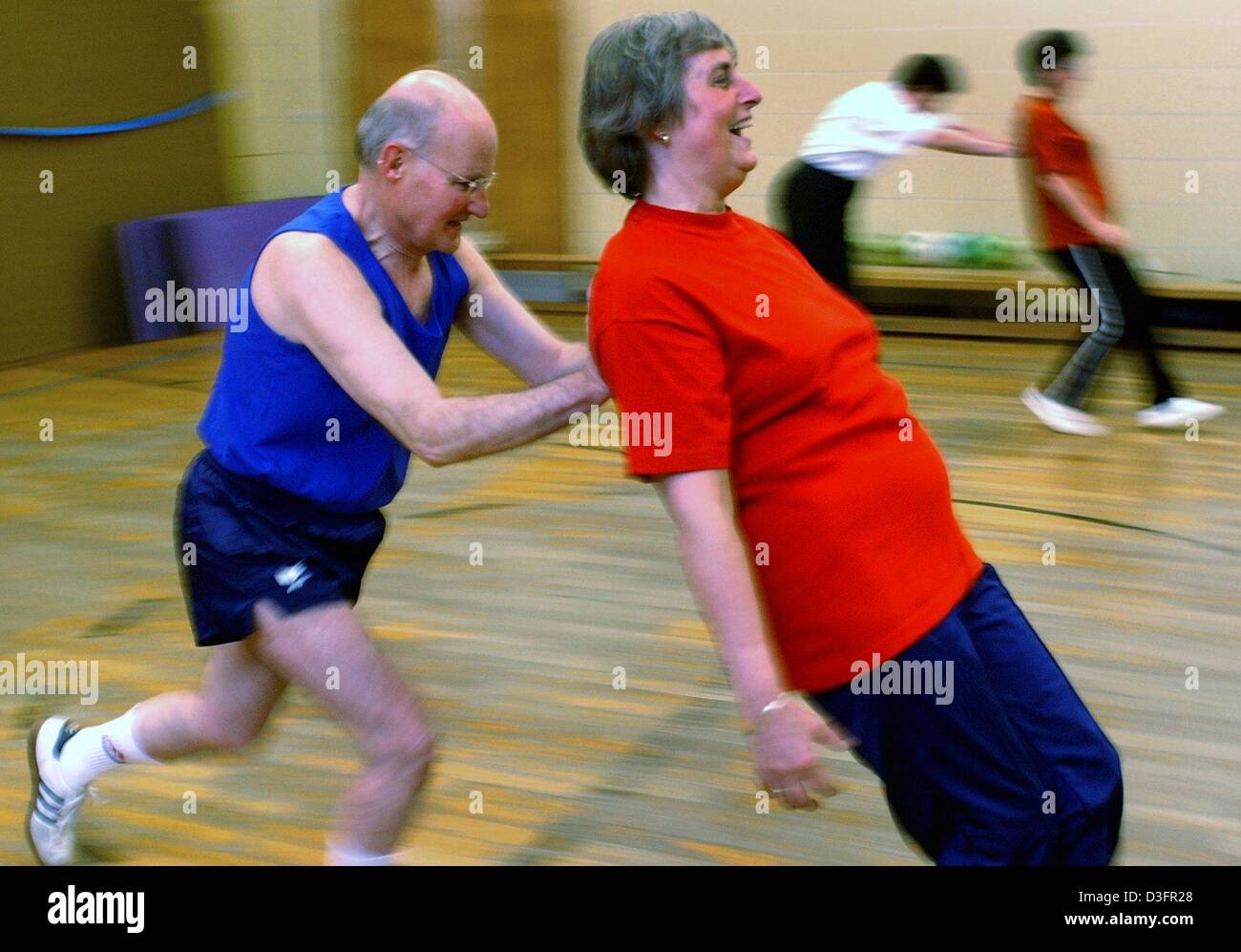 (dpa) - A couple of senior citizens conduct a sporting excersise during an exercise programme at a sports club in Berlin, 28 April 2003. Senior women and men, members of the sports club, are keeping fit through sporting exercises. The Berlin regional sports association has around 529,529 members. 122,506 are over the age of 50. 23.1 percent are active in sports groups for seniors.  Stock Photo