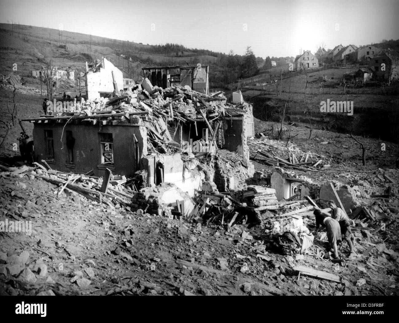 (dpa files) - Inhabitants search for usable household items in the destroyed houses in Pruem, post-war Germany, 15 August 1949. On 15 August 1949 more than 500 tons of ammunition, remnants of the German army in World War II, exploded in a subterranean bunker near Pruem. Large parts of the town of Pruem were destroyed. 11 people died and around 150 people were seriously injured. Stock Photo