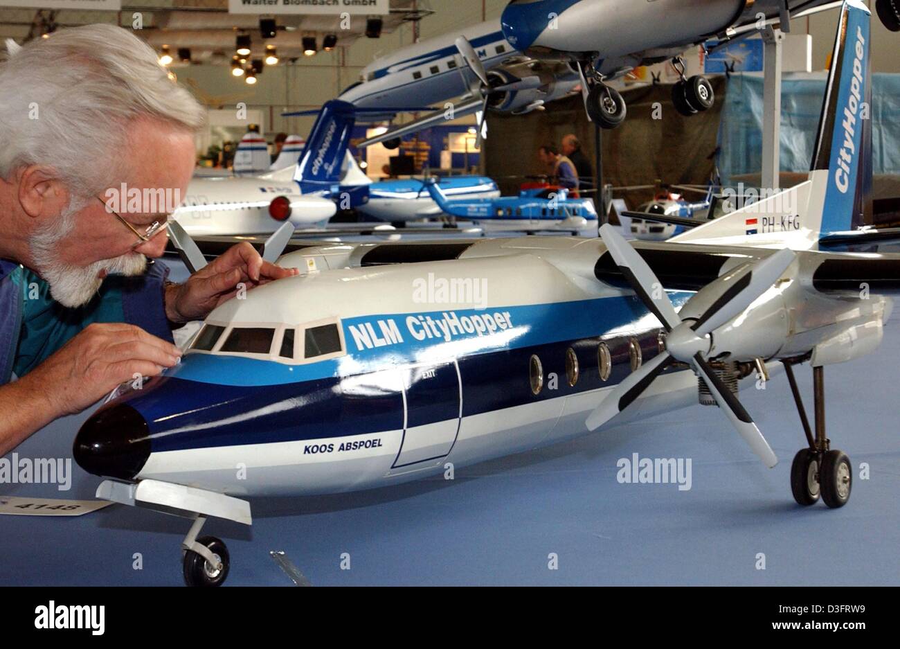 (dpa) - Rom Bakker puts the finishing touches on his volant airplane model of a Fokker F 27 on display at the trade fair for model making in Dortmund, Germany, 8 April 2003. Stock Photo