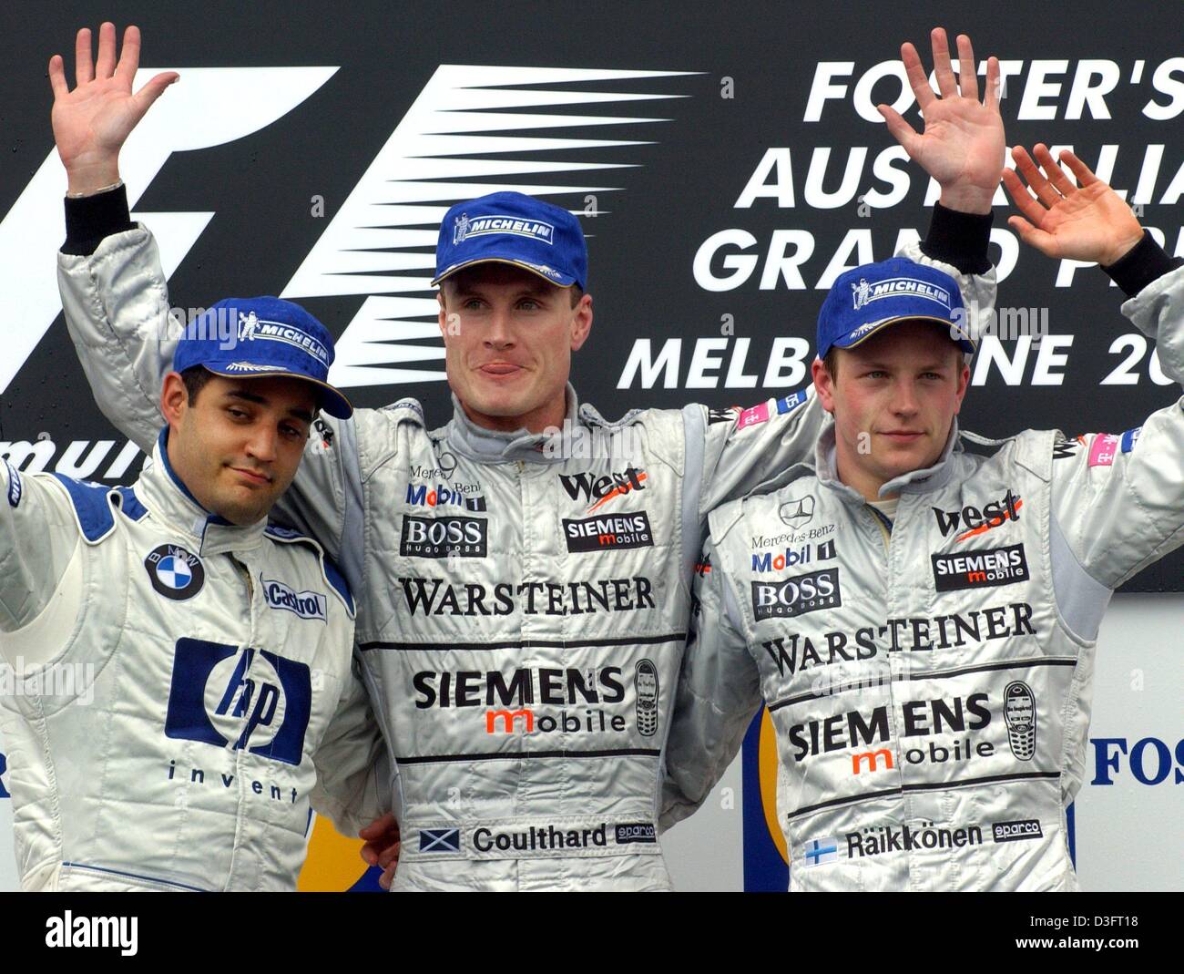 (dpa) - Scottish formula one pilot David Coulthard (C) of McLaren-Mercedes cheers with his Finnish team member Kimi Raeikkoenen (R) and Colombian Juan Pablo Montoya (L) of BMW Williams on the race-track in Melbourne, Australia, 9 March 2003. He wins the year's first race of the formula one for the Grand Prix of Australia and celebrates his 13th victory in his 142nd formula one race Stock Photo