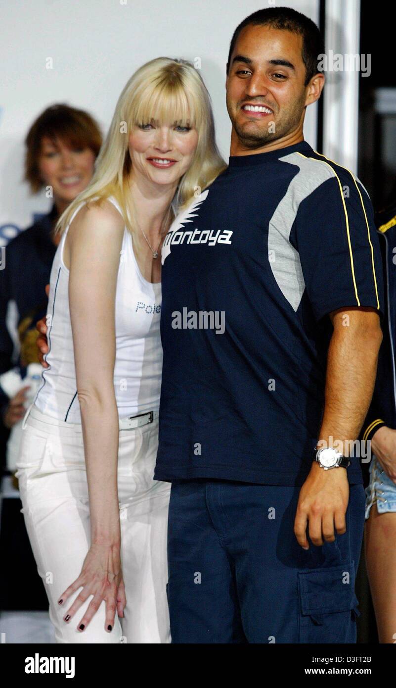 (dpa) - German top model Nadja Auermann ducks to be smaller while Colombian formula one pilot Juan Pablo Montoya stands straight to appear bigger, after the BMW fashion show in Barcelona, 2 May 2003. Stock Photo