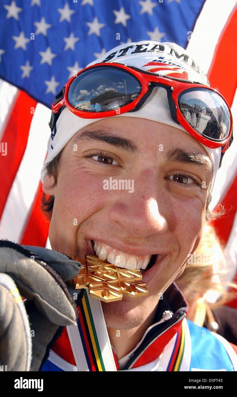 (dpa) - US skier Johnny Spillane bites his gold medal during the award ceremony of the Nordic Skiing World Championships in Lago di Tesero in Val di Fiemme, Italy, 28 February 2003. He won the nordic combined gold medal in the 7.5km nordic combined sprint event. Stock Photo