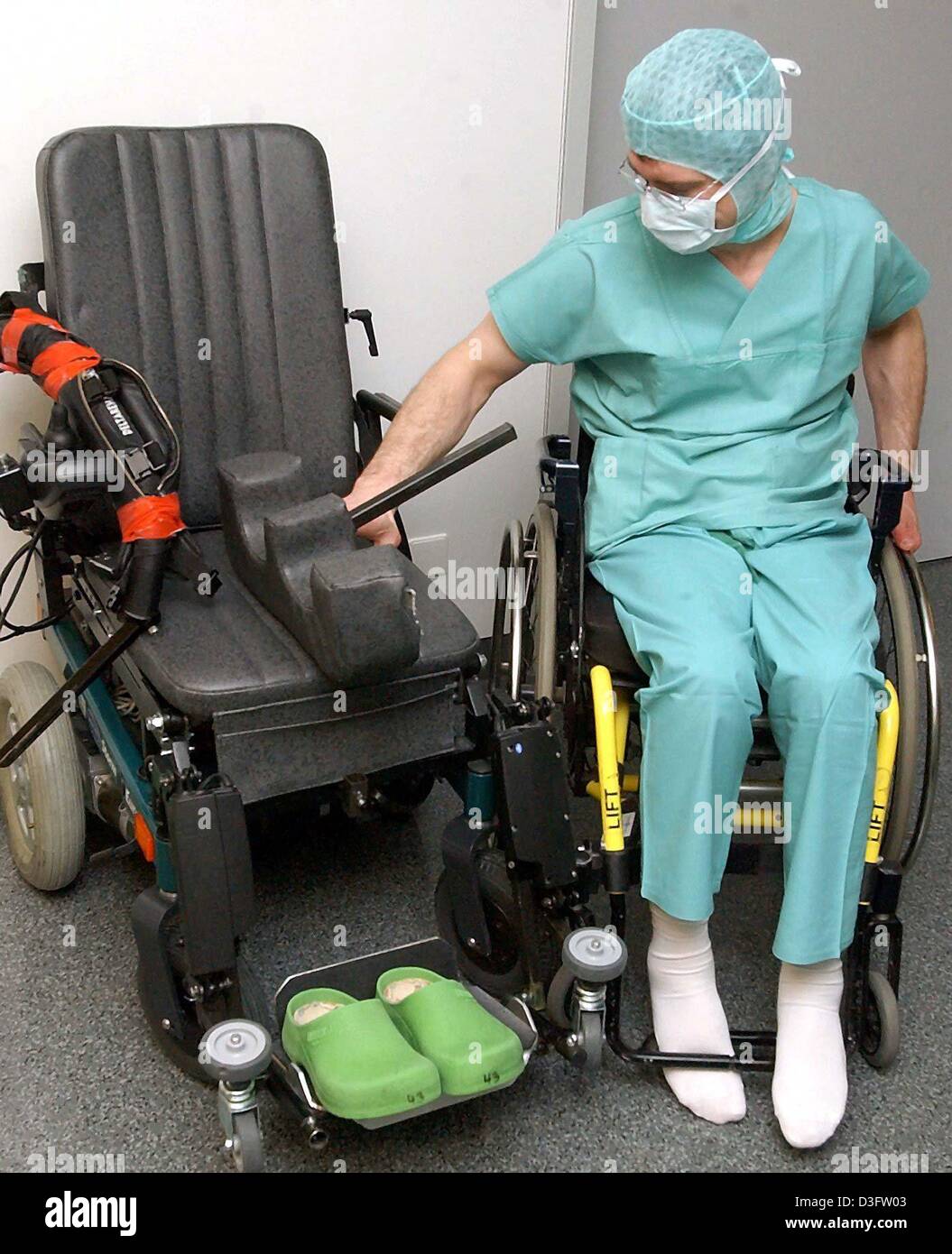 (dpa) - Neurosurgeon Frank Roehrich moves from his wheel chair into his ...