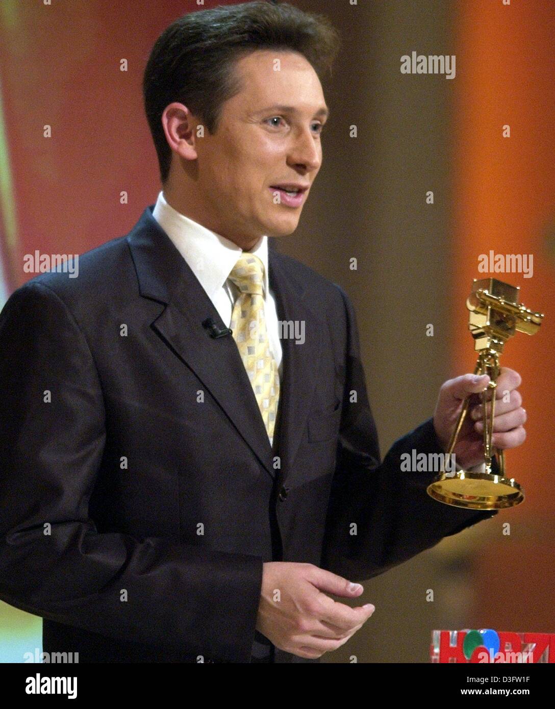 (dpa) - Belgian singer Helmut Lotti poses with his trophy during the Golden Camera awards show in Berlin, 4 February 2003. Lotti won the award in the category Classic-Pop. The Golden Camera was awarded in 16 categories for the 38th time by the German TV journal 'Hoerzu' ('listen'). Stock Photo