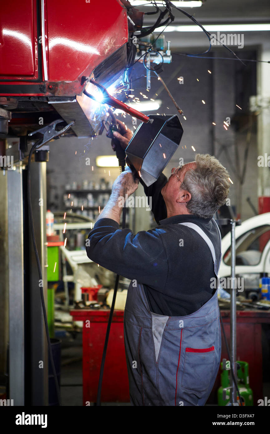 A car mechatronic during welding Stock Photo