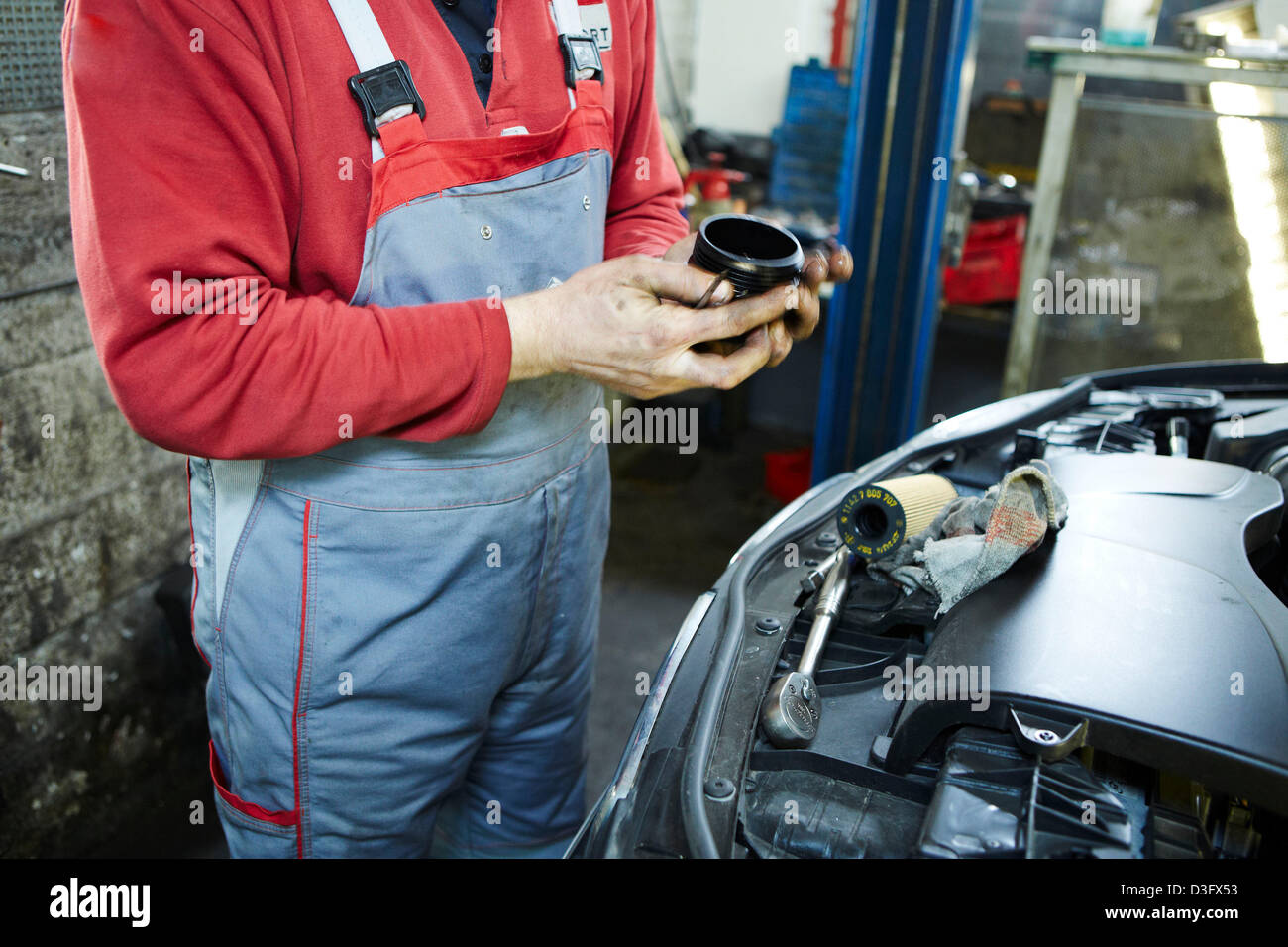 Car mechanic changing oil filter Stock Photo Alamy