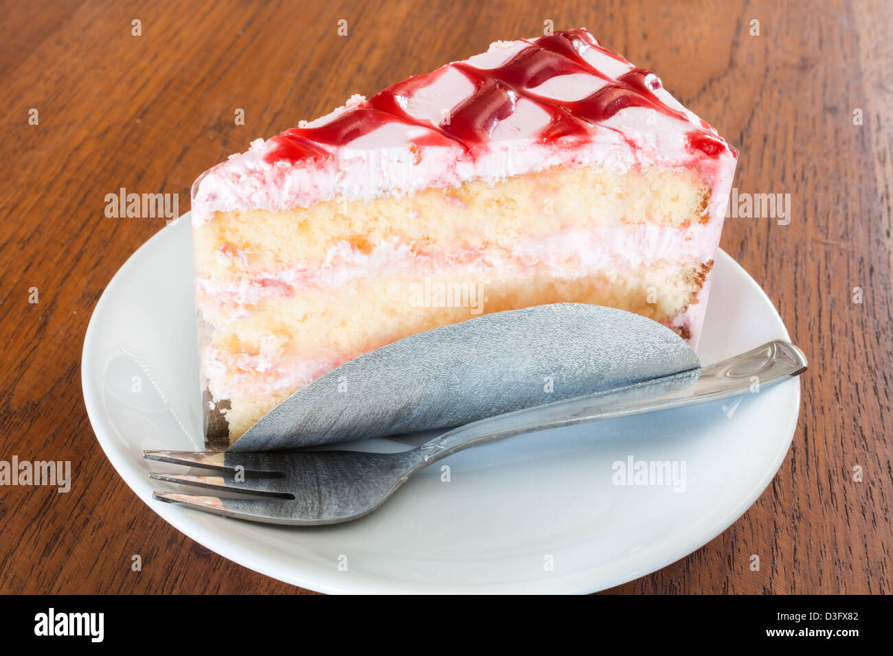 White chocolate cake topping with cherry sauce Stock Photo Alamy